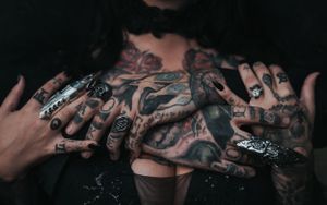 Gothic Tattooed Couple his hands are around her and hers are resting on his